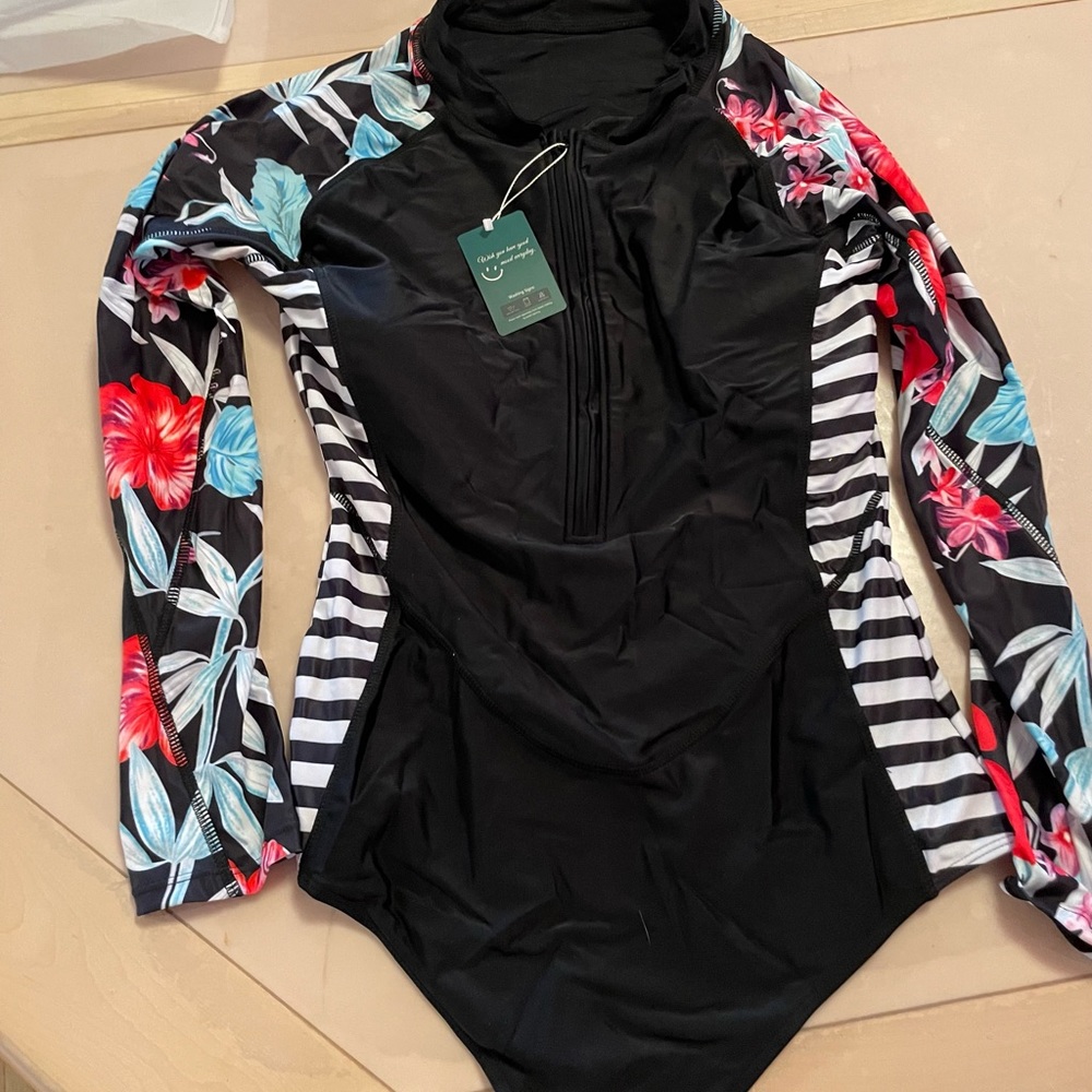 One piece long sleeve bathing suit. Never worn.